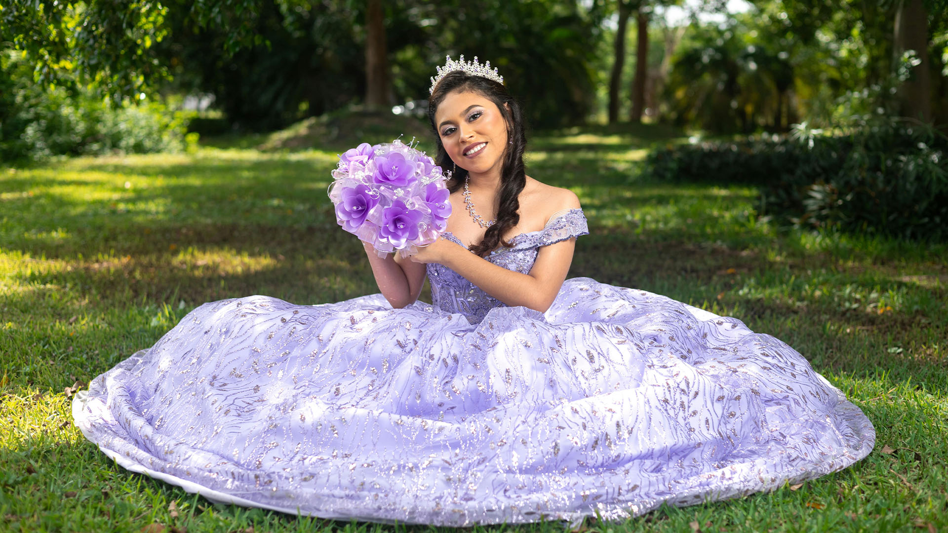 young girl in purple dress holding flowers